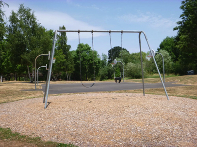 Swing set with child swing close to the basketball courts